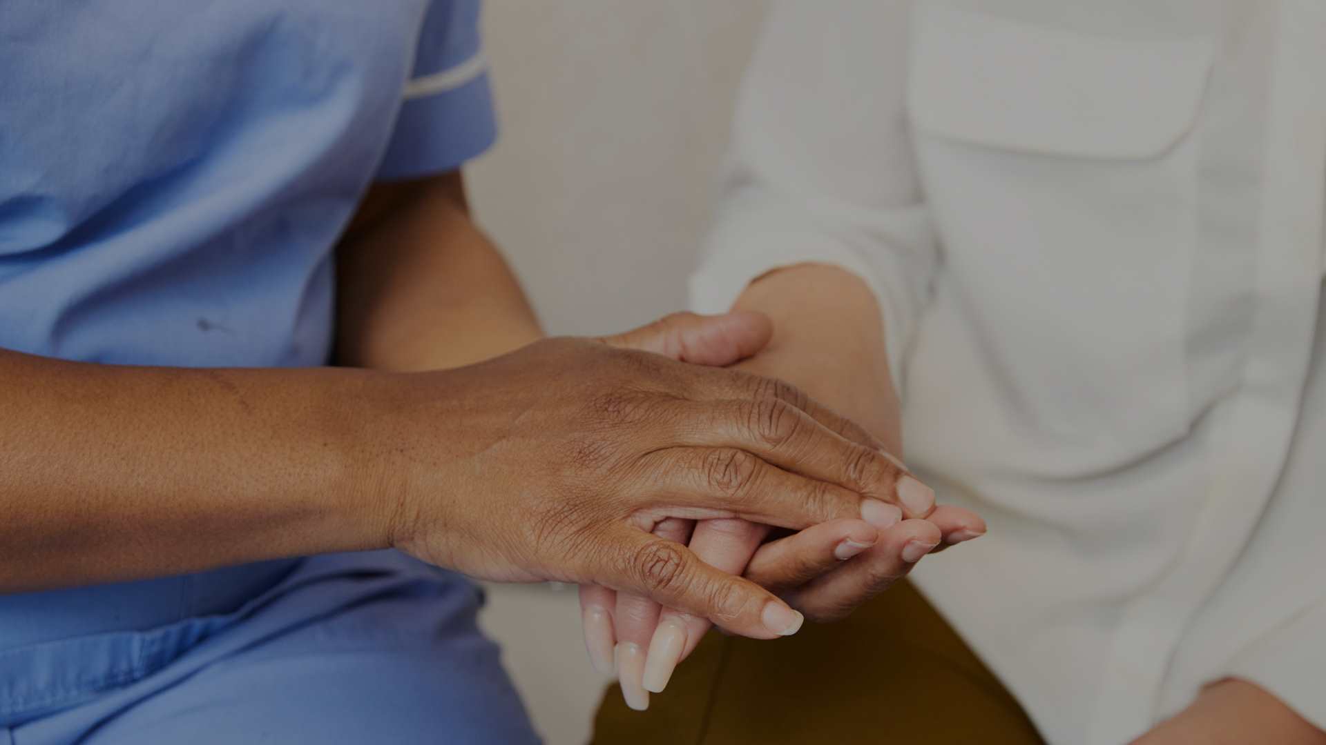 Midwife holding client hand