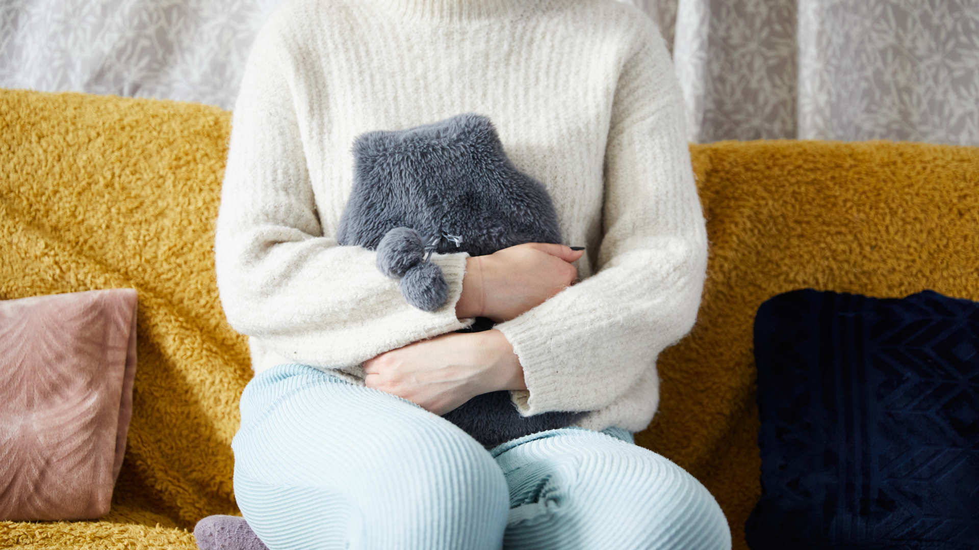 Client with hot water bottle against stomach