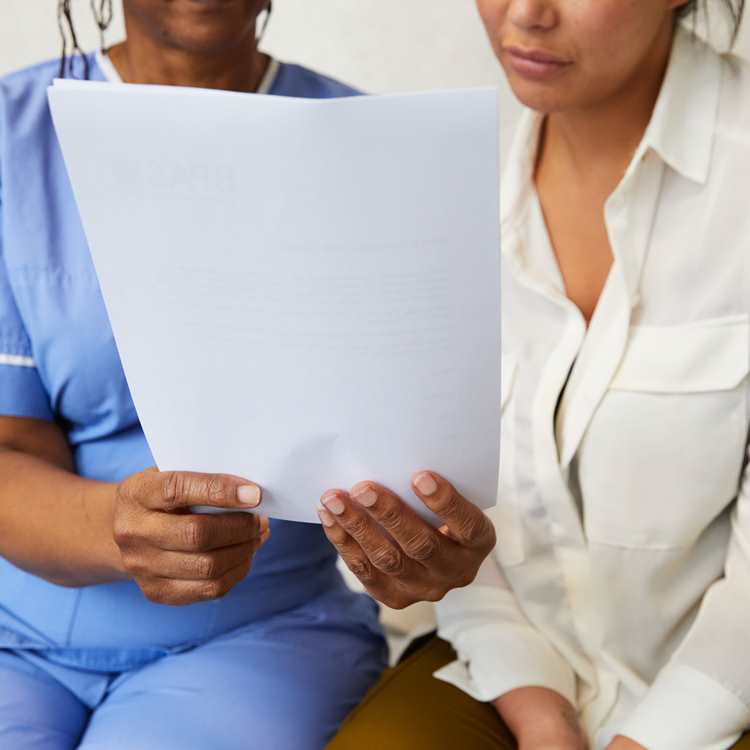 Midwife with patient reviewing documentation