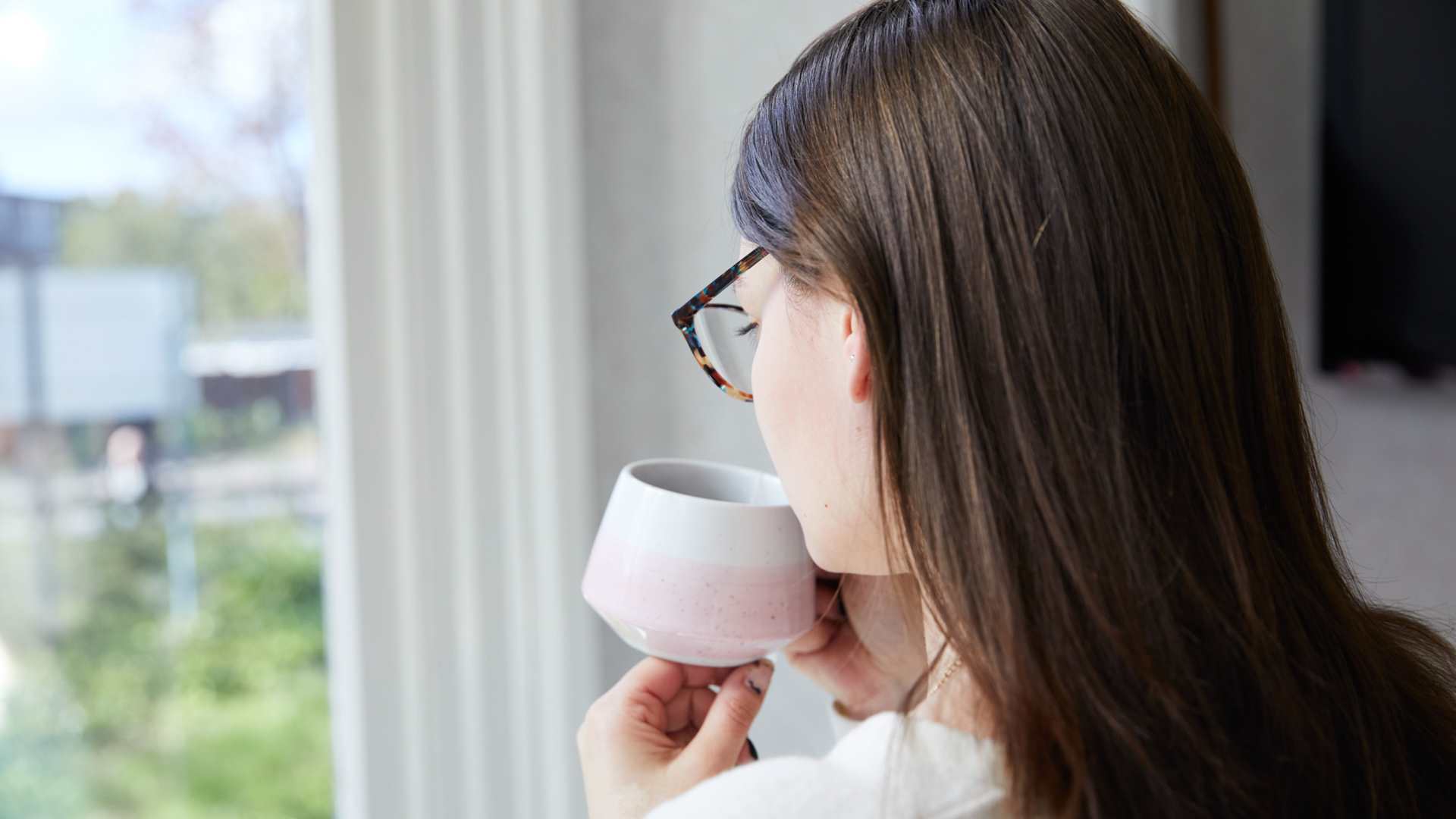 Client drinking coffee near window