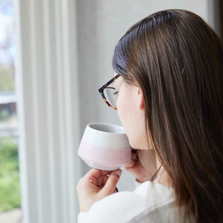 Client drinking coffee near window