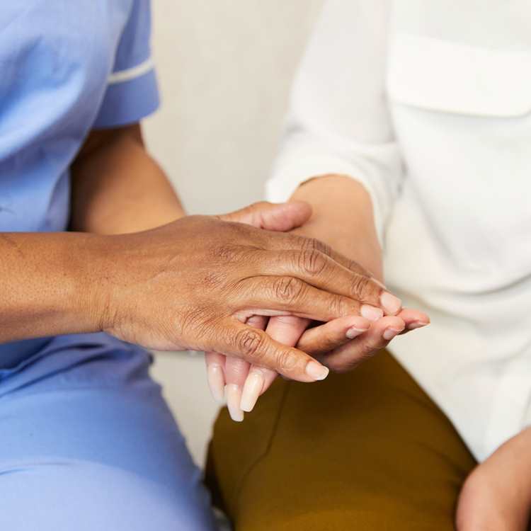 Midwife holding clients hand