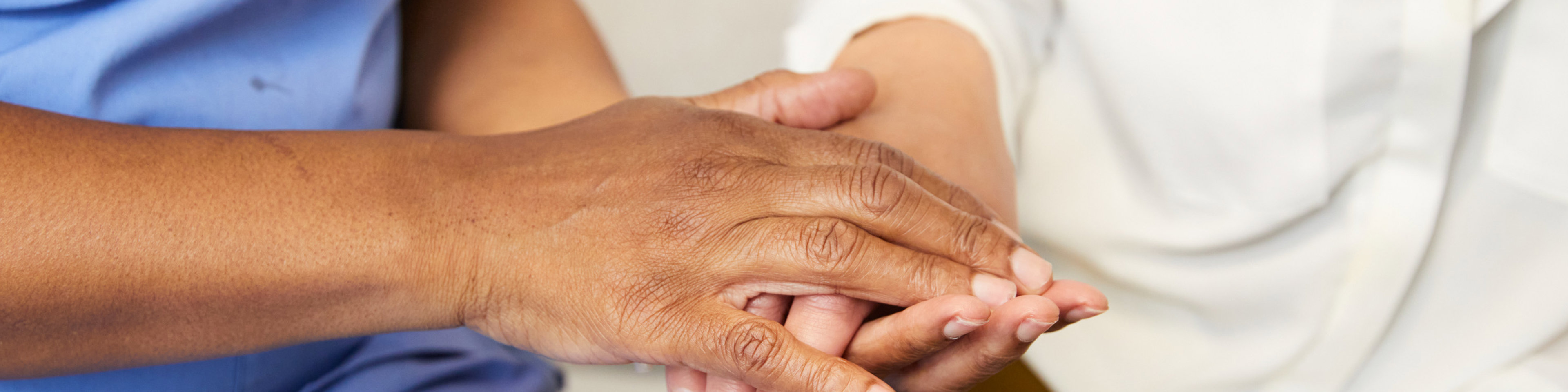 Midwife holding clients hand