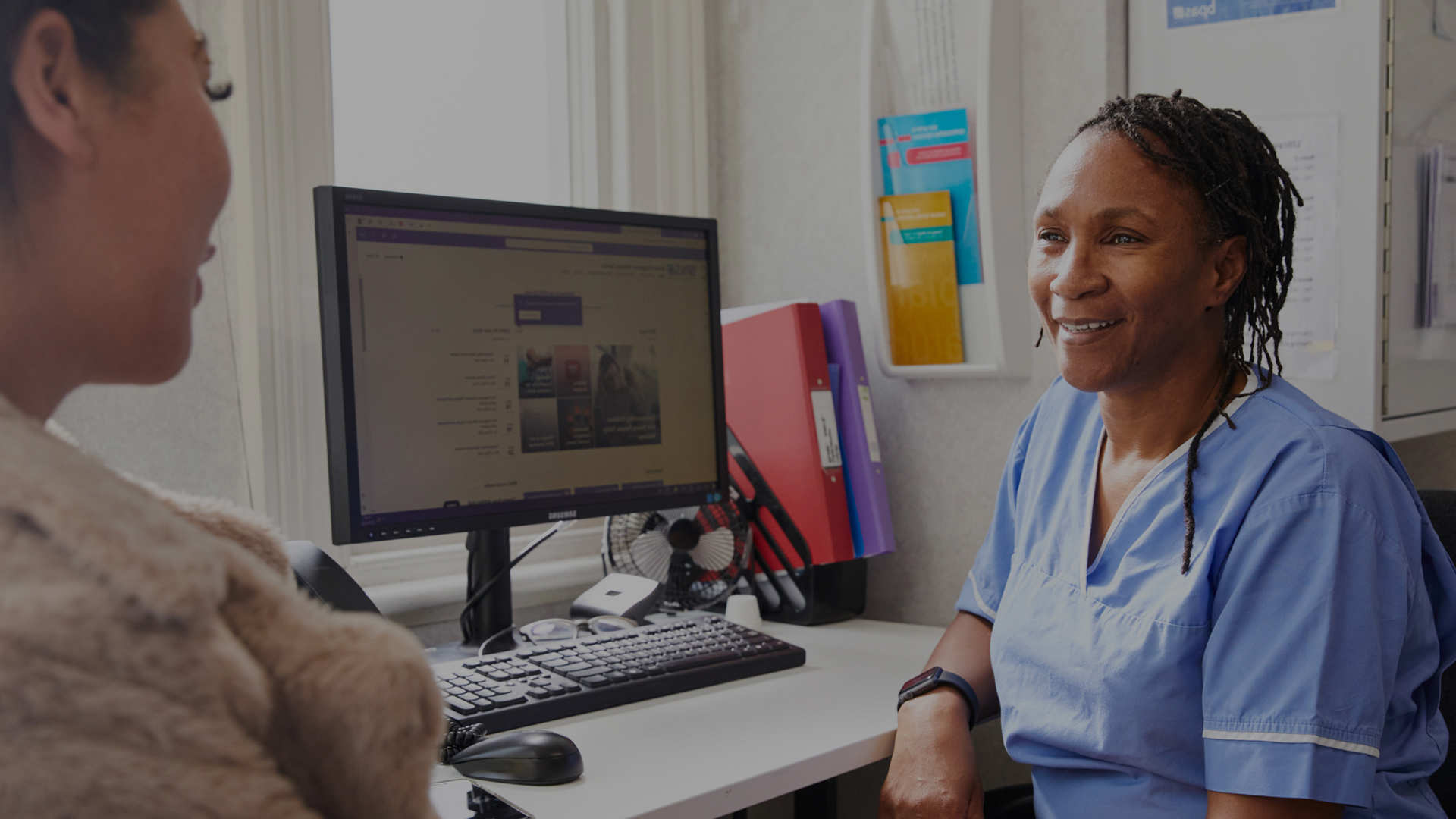 Midwife talking to client