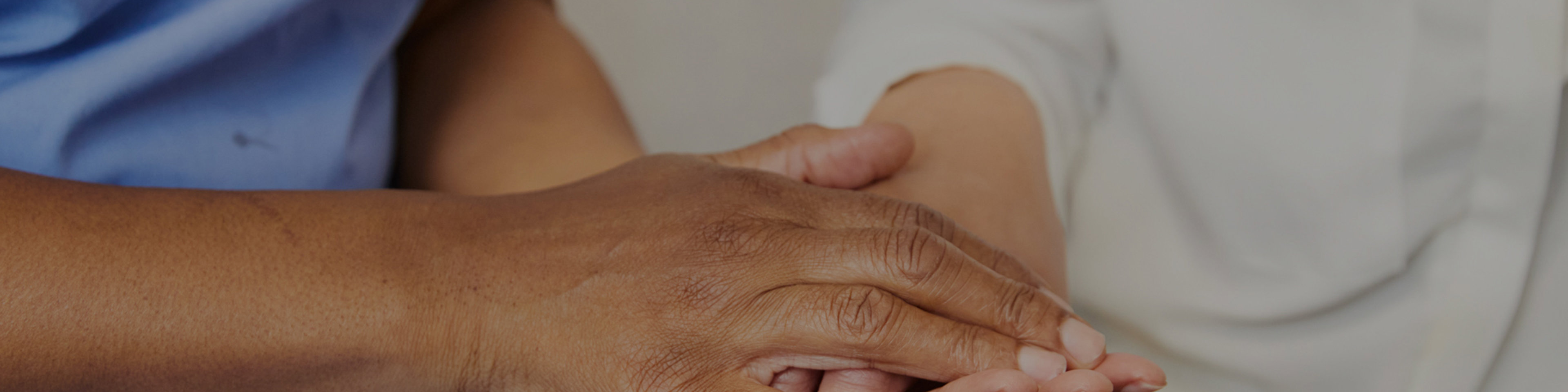 Midwife holding client hand